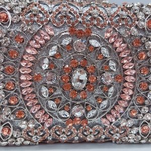 Macro detail of luxury dinner bag featuring crystal mandala patterns and rose gold rhinestones