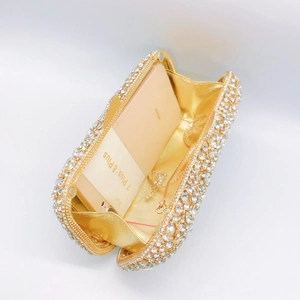 Luxury rhinestone clutch evening bag with gold chain strap shown from an open perspective