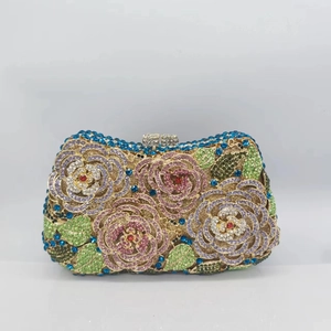 Detail of luxury metal clutch bag with colorful rhinestones in rose flower patterns