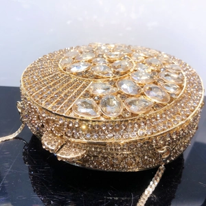 Macro view of gold evening clutch featuring pear-shaped crystals and fine rhinestones