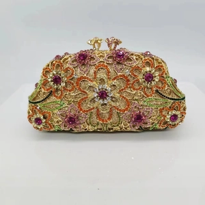 Detailed view of floral rhinestone patterns and double flower clasp on shell evening bag