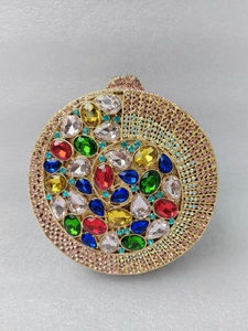 Detailed front view of circular gold evening clutch with vibrant multicolored rhinestones