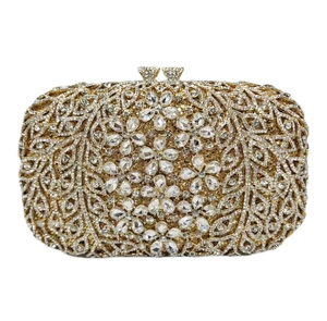 Close-up of sparkling floral rhinestones and crystal clasp on golden evening clutch bag