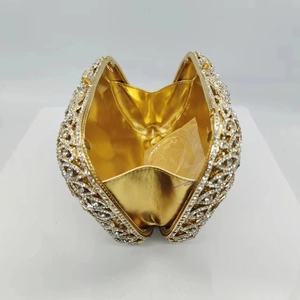 Hollow gold metal evening clutch bag with sparkling rhinestones in a heart shaped design