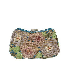 Luxurious floral evening clutch with colorful crystals and gold metal frame on white back