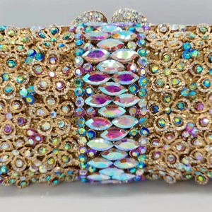 Golden hollow metal clutch bag with colorful rhinestones and marquise crystal details