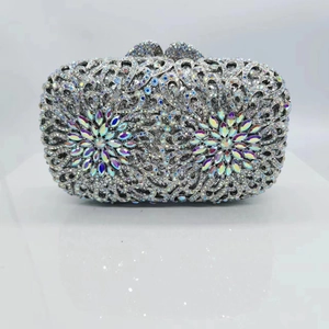 Close-up of hollow metal evening clutch bag with sparkling crystals and silver frame