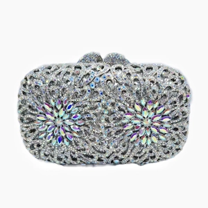 Detailed view of silver crystal evening clutch featuring colorful rhinestone floral designs