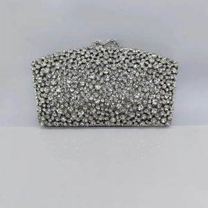 Macro shot of silver evening clutch bag with sparkling pavé crystals and metal clasp
