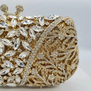 Luxury gold crystal clutch bag with hollow floral metal carving and sparkling rhinestones