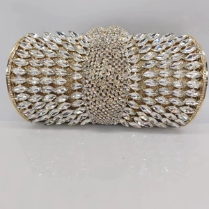 Detailed close-up of golden hollow metal frame with marquise crystal rhinestones on clutch bag