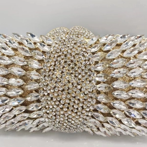 Detail of luxury gold evening clutch featuring intricate marquise crystal embellishments
