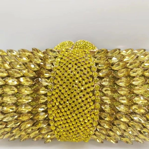Macro shot of gold crystals and marquise-cut rhinestones on the luxury evening clutch bag