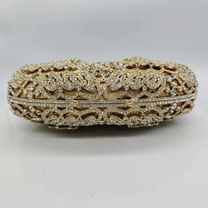Exquisite gold crystal evening bag with hollow butterfly patterns and sparkling rhinestones
