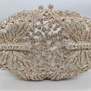 Detailed view of the sparkling crystal butterfly motif on a luxury evening clutch bag
