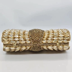 Close-up of bow-shaped evening clutch featuring luxury marquise and round crystals