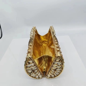 Detailed interior of a gold crystal evening clutch with sparkling rhinestone exterior