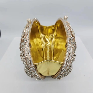 Detail view of the golden interior and crystal-studded texture of this evening clutch bag
