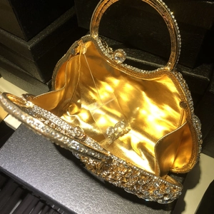 Luxury gold oval crystal clutch bag with sparkling rhinestones and golden lining for evening gala