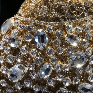 Luxury oval crystal evening clutch bag with gold filigree and sparkling diamonds
