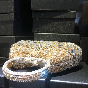 Luxurious gold crystal clutch with sparkling diamond handle for formal evening banquets