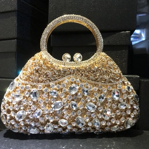 Close-up of luxury crystal clutch bag with gold metal base and sparkling rhinestones