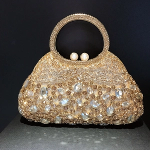 Detailed macro view of luxury crystal evening clutch with champagne diamonds and pearl clasp