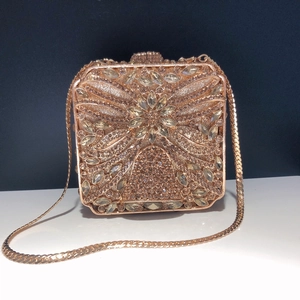 Luxurious rose gold evening clutch bag with sparkling floral crystal patterns and chain