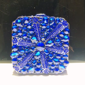 Elegant silver frame evening clutch featuring blue sunflower rhinestone patterns and crystals