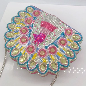 Macro detail of luxury peacock shell clutch bag with vibrant colorful rhinestones