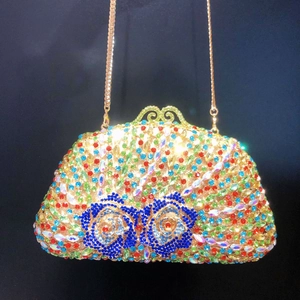 Close-up of colorful rhinestones floral pattern and golden clasp on the evening bag