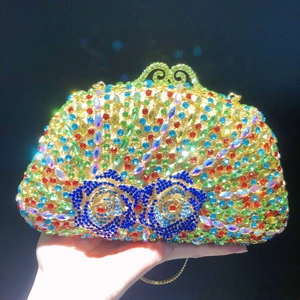 Detailed close-up of colorful rhinestones on an elegant gold metallic evening clutch bag