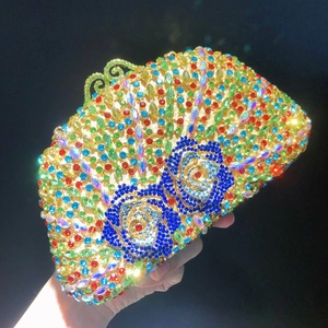 Macro shot of colorful rhinestones and blue rose floral patterns on luxury clutch