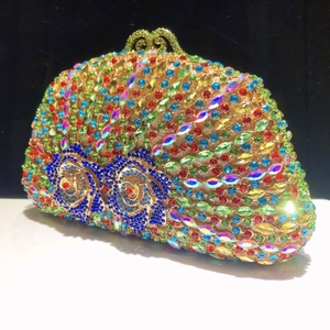 Macro detail of luxury evening clutch featuring colorful rhinestones and blue rose patterns