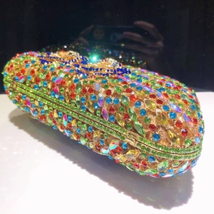 Close-up of colorful rhinestones and gold metal craft on luxury D-shaped evening clutch