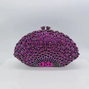 Detail of fan-shaped clutch featuring vibrant pink rhinestones and dark metal hardware