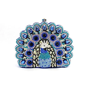 Detail of peacock luxury clutch with blue crystal rhinestones and metal closure