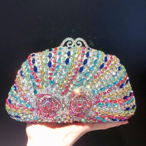 Detail of evening clutch featuring colorful rhinestones and ornate metal hollow clasp