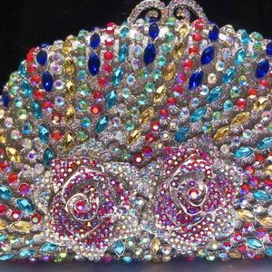 Macro detail of colorful crystal rhinestones forming rose patterns on evening clutch