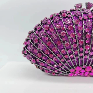 Close-up of pink crystal fan evening bag with luxury rhinestone metal frame details