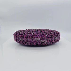 Macro view of hot pink rhinestone fan-shaped evening clutch with silver metal hardware