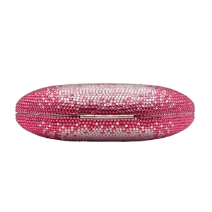 Detail of pink rhinestone gradient on an oval evening clutch bag with silver metal hinge
