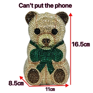 Detail of luxury teddy bear clutch with silver and gold rhinestones and clover pattern