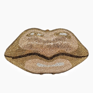 Macro shot of lip-shaped clutch bag encrusted with gold and black sparkling crystals