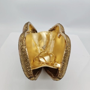 Detail of champagne gold rhinestone clutch bag interior with detachable snake chain