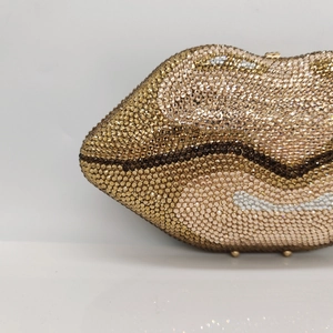 Macro shot of gradient rhinestones on high-end lip-shaped evening clutch bag