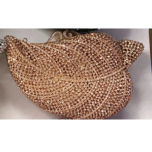 Macro shot of leaf-shaped evening clutch with sparkling rhinestones and metal closure