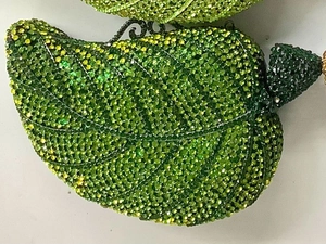 Macro detail of leaf-shaped evening clutch with green gradient crystal rhinestones