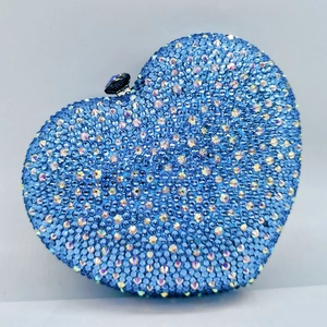 Detail of heart-shaped evening clutch featuring dense blue rhinestones and a jeweled clasp