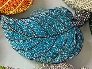 Detailed view of leaf-shaped evening clutches with blue and pink crystal rhinestones